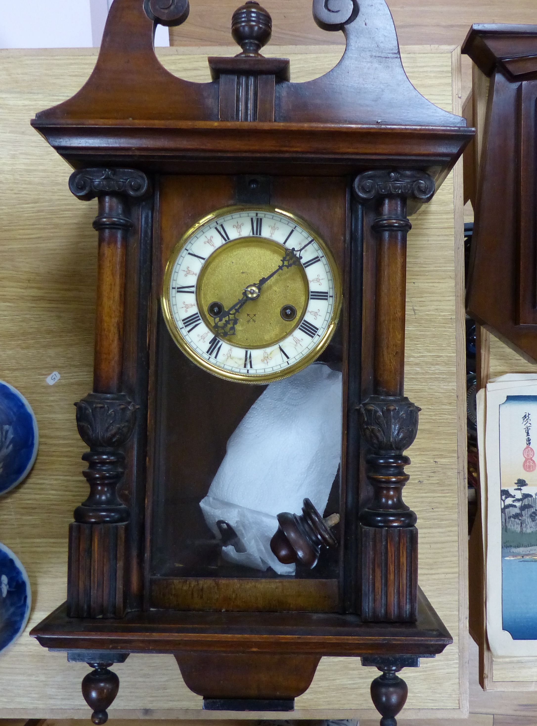 A 19th century German walnut wall clock with pendulum and key, height 58cm, and a mahogany barometer